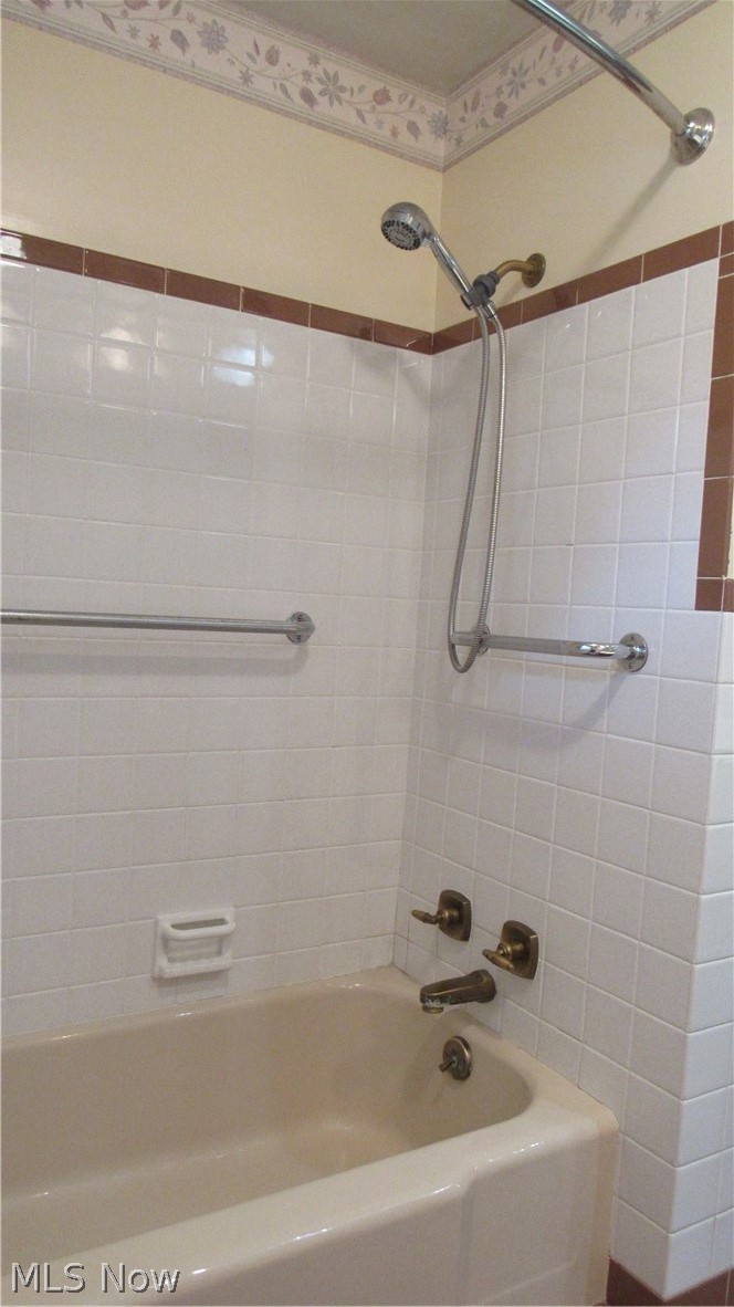 6841 Navarre Road Southwest Massillon, OH 44646 - Photo 17 of 50 Ttiled shower surround with a built-in tub and chrome fixtures