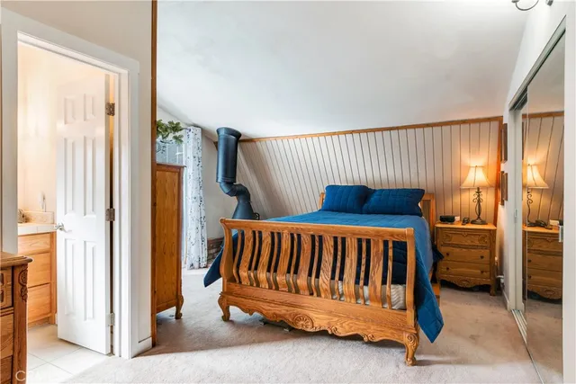 a living room with furniture a rug and white walls