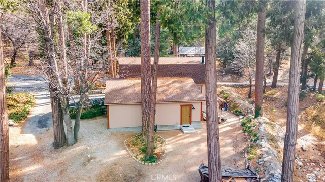 a view of a house with a yard and sitting area