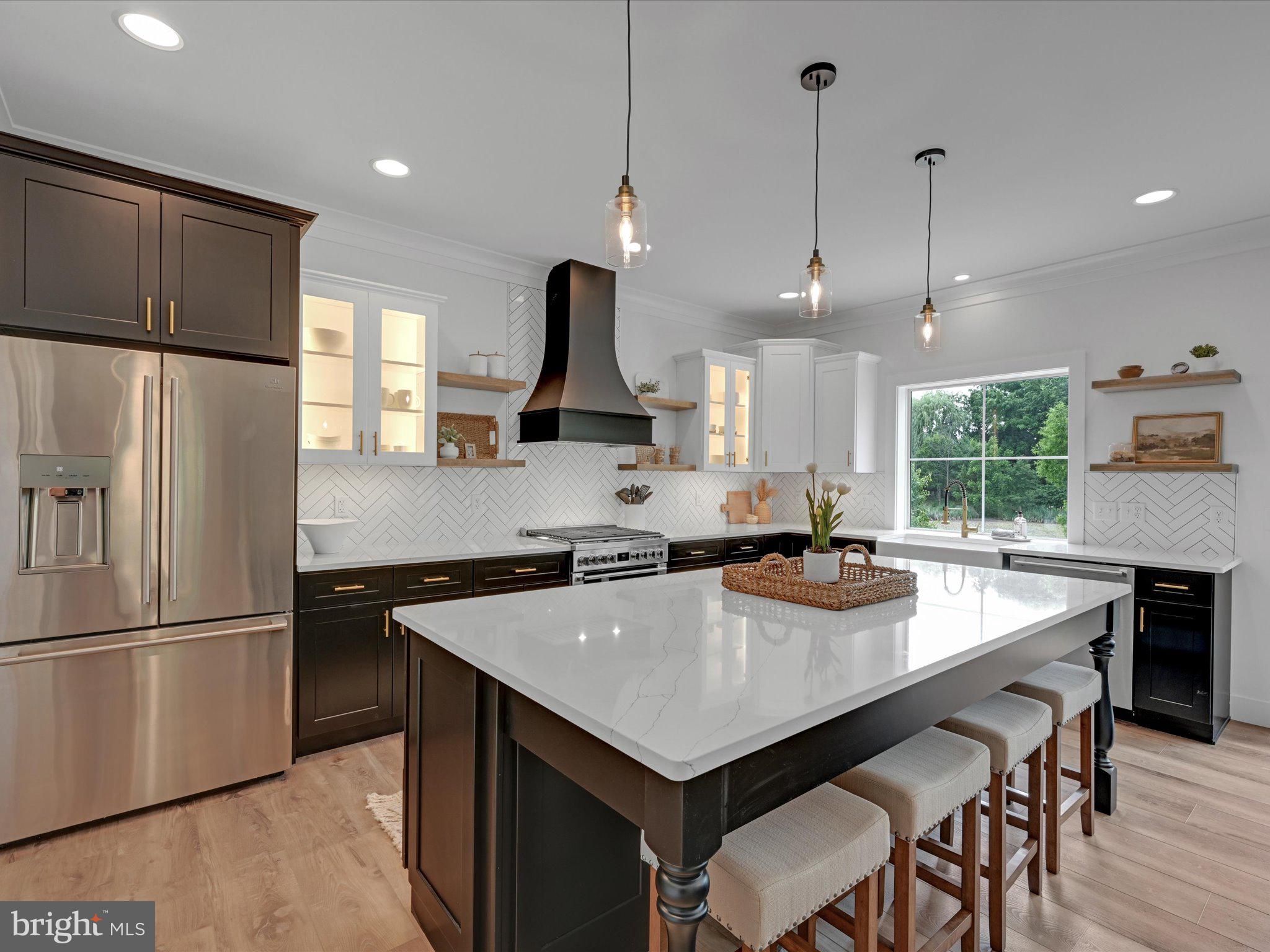 335 Royal Hunt Way Lititz, PA 17543 - Photo 21 of 49 a kitchen with a stove a refrigerator a sink and a table