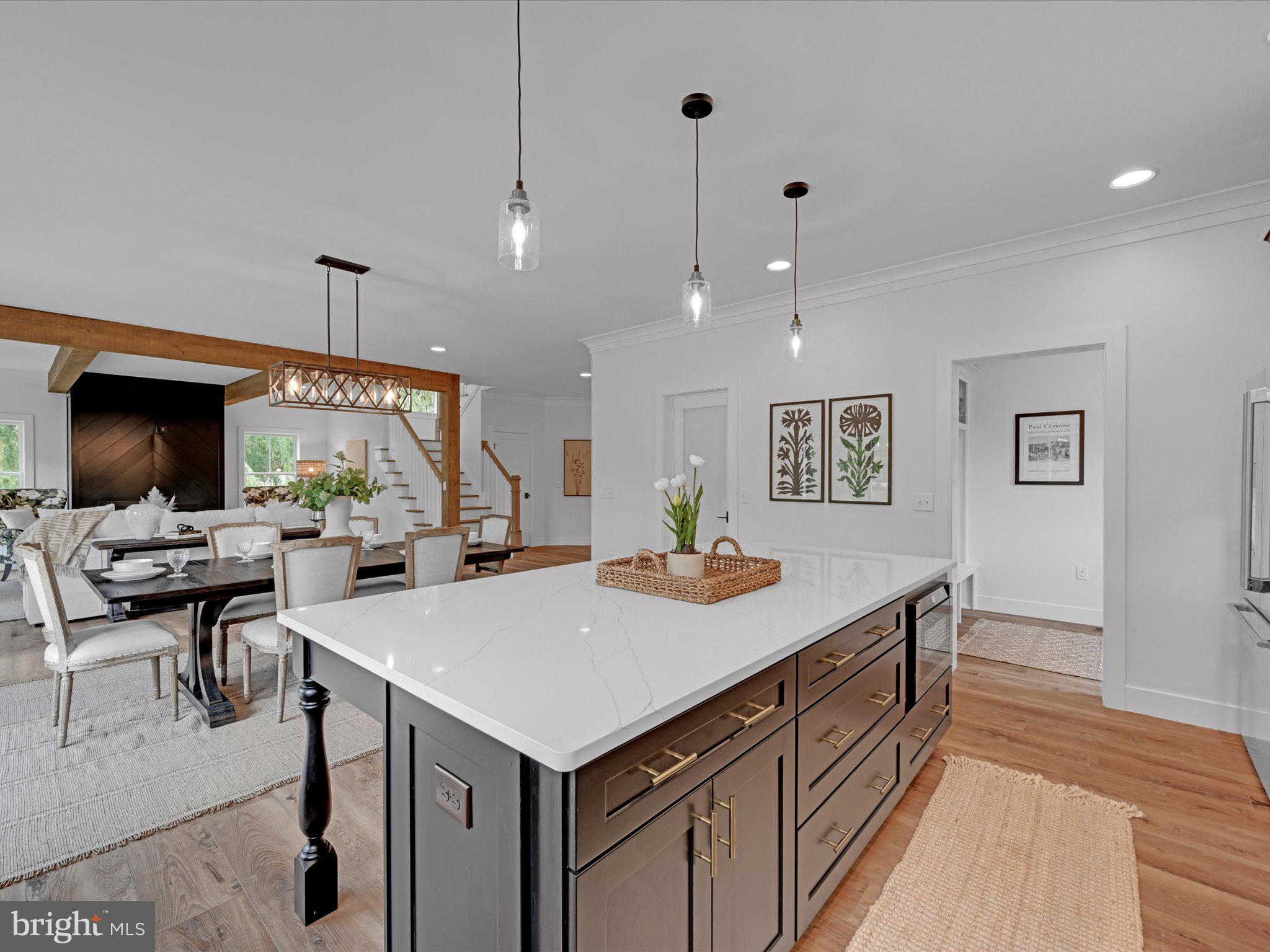 335 Royal Hunt Way Lititz, PA 17543 - Photo 23 of 49 a view of kitchen island a sink wooden floor and a living room view