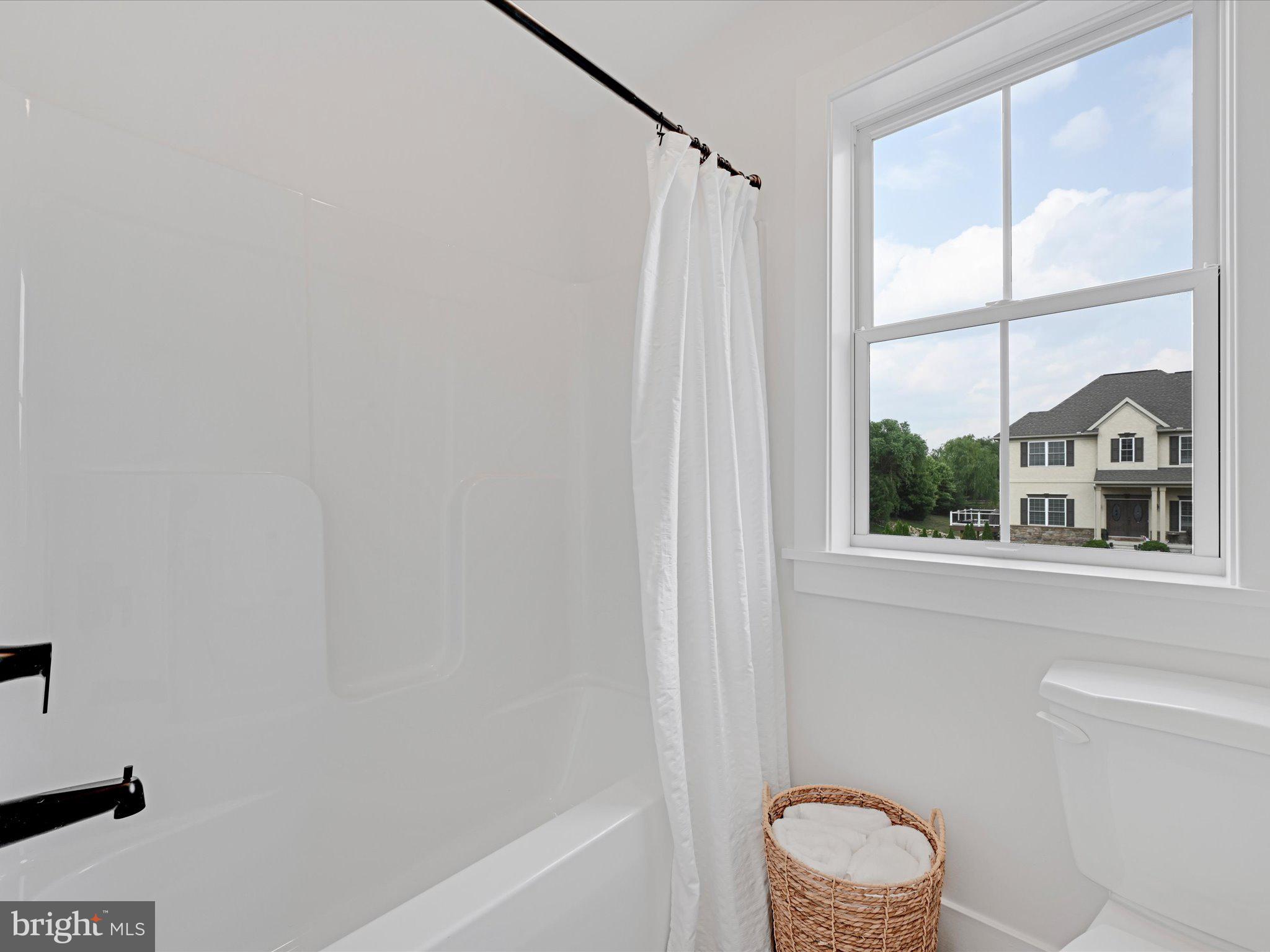 335 Royal Hunt Way Lititz, PA 17543 - Photo 36 of 49 a bathroom with a window a bathtub and a window
