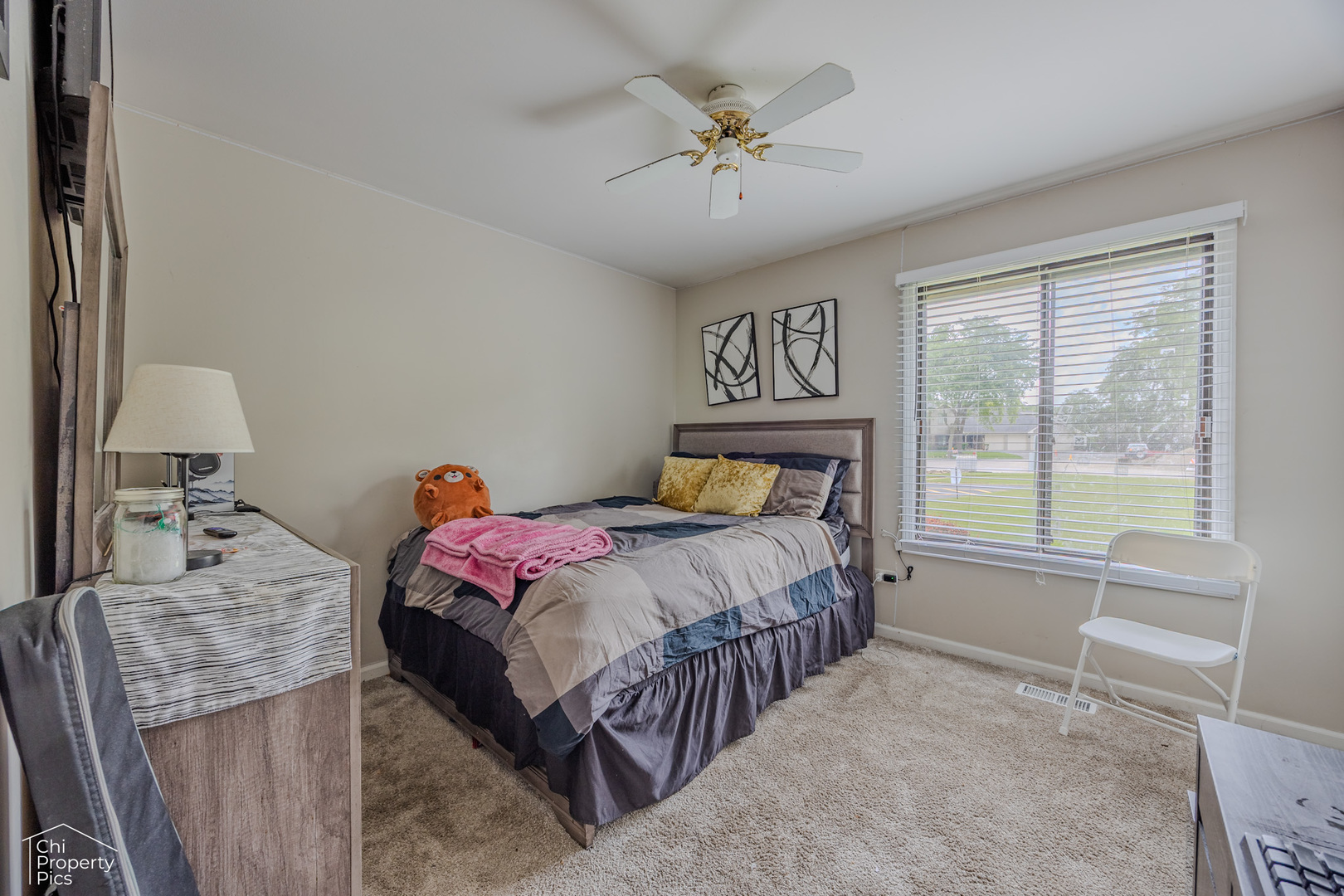 630 Cumberland Trail, Unit AA1 Roselle, IL 60172 - Photo 13 of 23 a bedroom with a bed a chandelier and a window