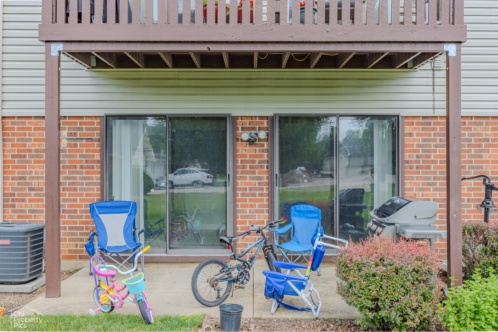 630 Cumberland Trail, Unit AA1 Roselle, IL 60172 - Photo 20 of 23 a front view of a house with outdoor seating and a potted plant