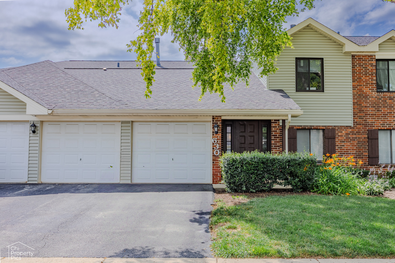 630 Cumberland Trail, Unit AA1 Roselle, IL 60172 - Photo 2 of 23 front view of house with a yard