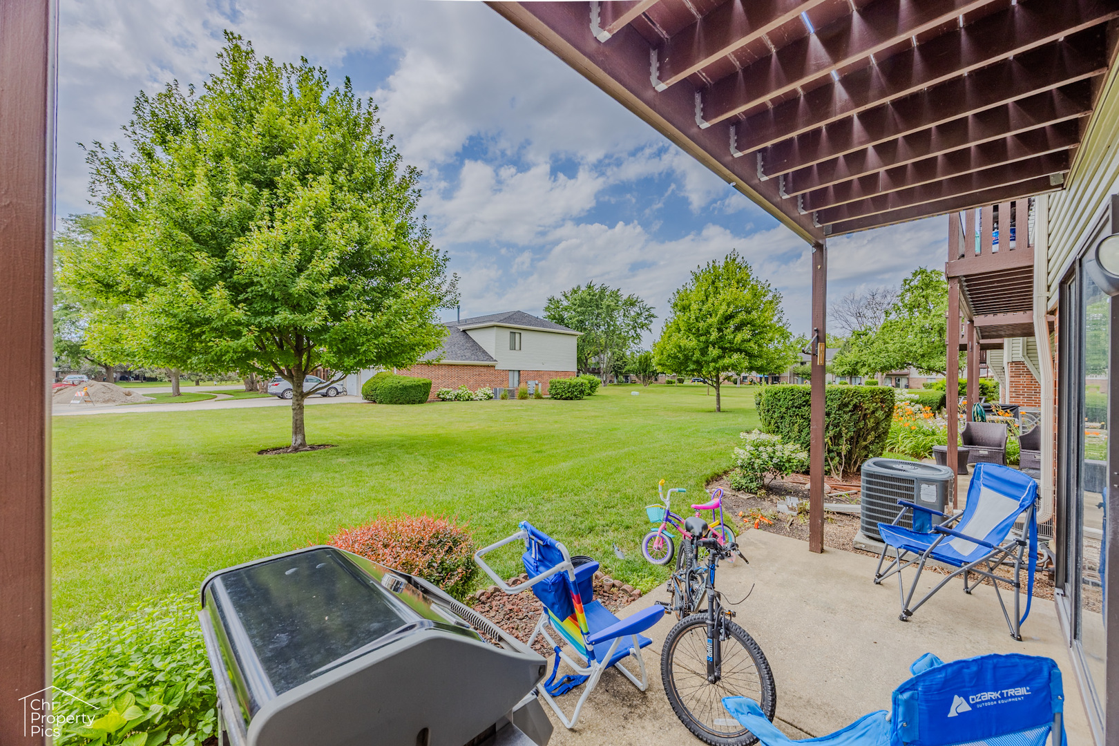 630 Cumberland Trail, Unit AA1 Roselle, IL 60172 - Photo 23 of 23 a view of a patio with table and chairs potted plants and a palm tree