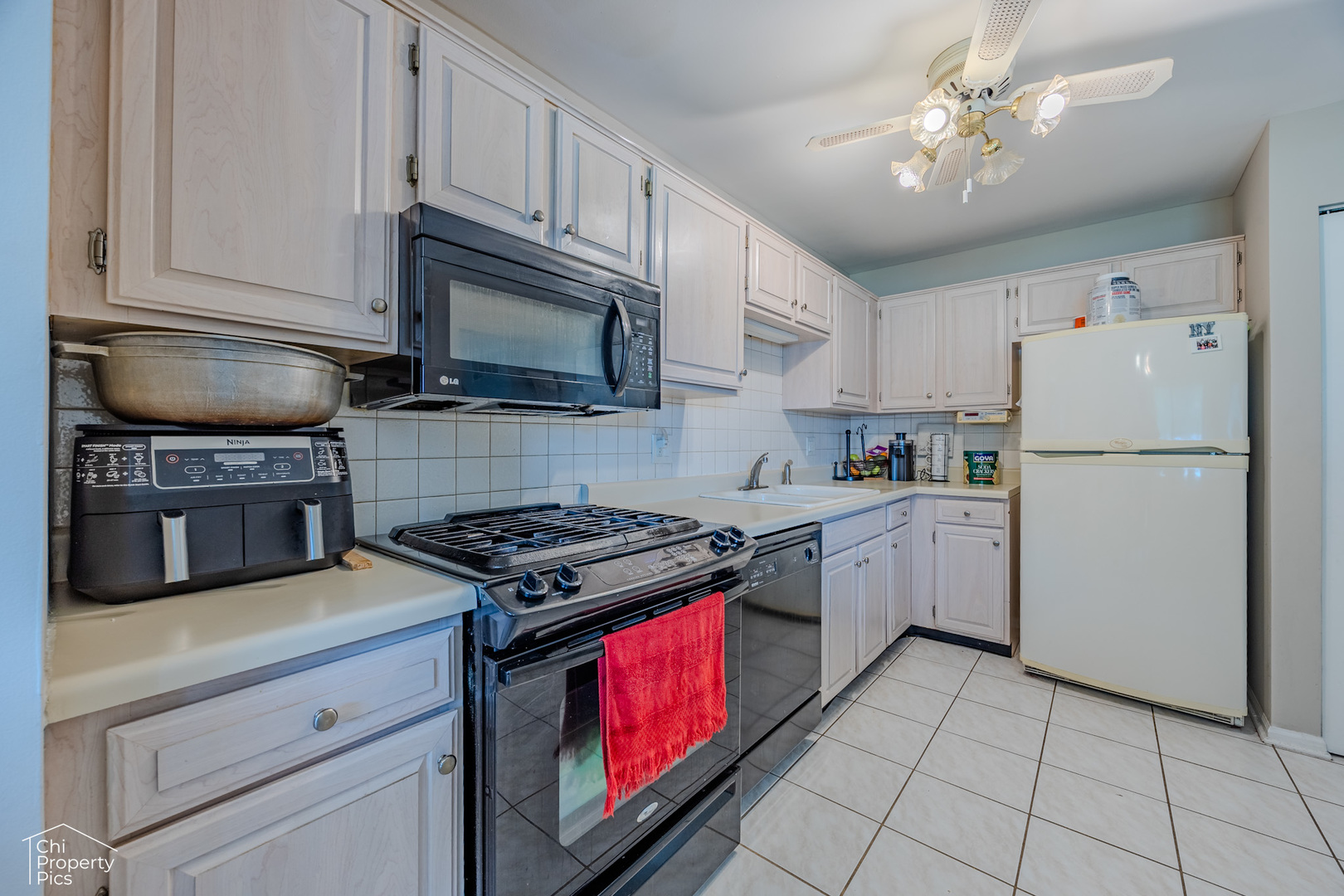 630 Cumberland Trail, Unit AA1 Roselle, IL 60172 - Photo 4 of 23 a kitchen with cabinets stainless steel appliances and a counter space