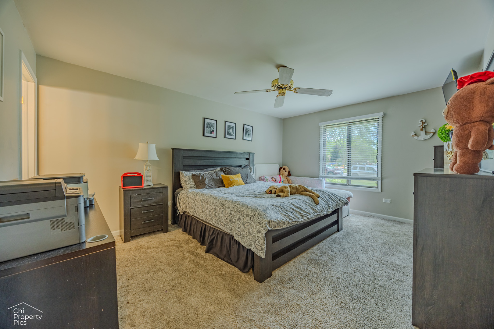 630 Cumberland Trail, Unit AA1 Roselle, IL 60172 - Photo 9 of 23 a bedroom with a bed and a chandelier