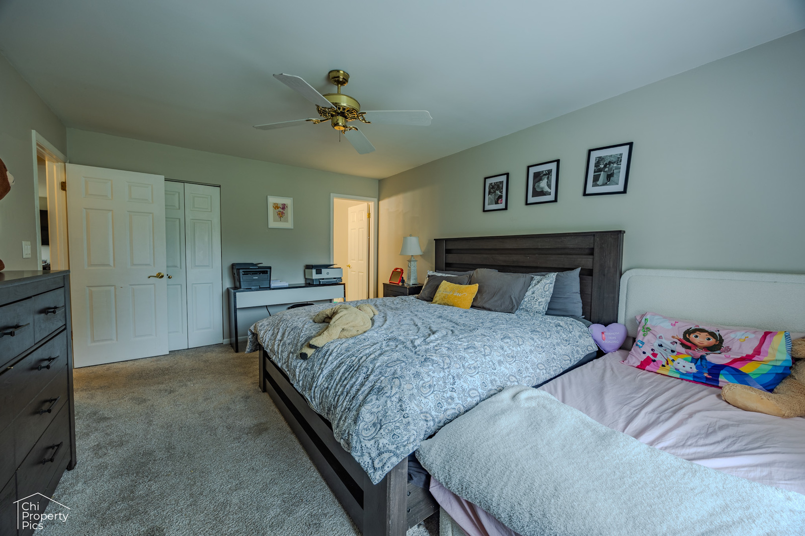 630 Cumberland Trail, Unit AA1 Roselle, IL 60172 - Photo 10 of 23 a bedroom with a bed and a chandelier