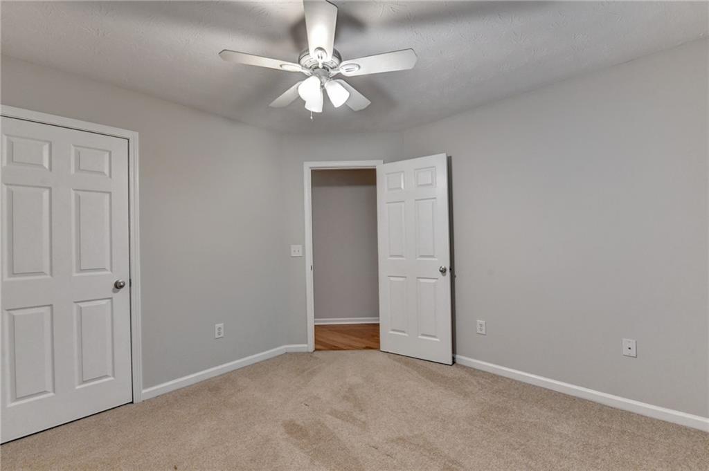 310 Andrew Ridge Drive Jefferson, GA 30549 - Photo 47 of 52 an empty room with a chandelier fan and closet