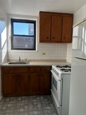 a kitchen with a stove sink and cabinets
