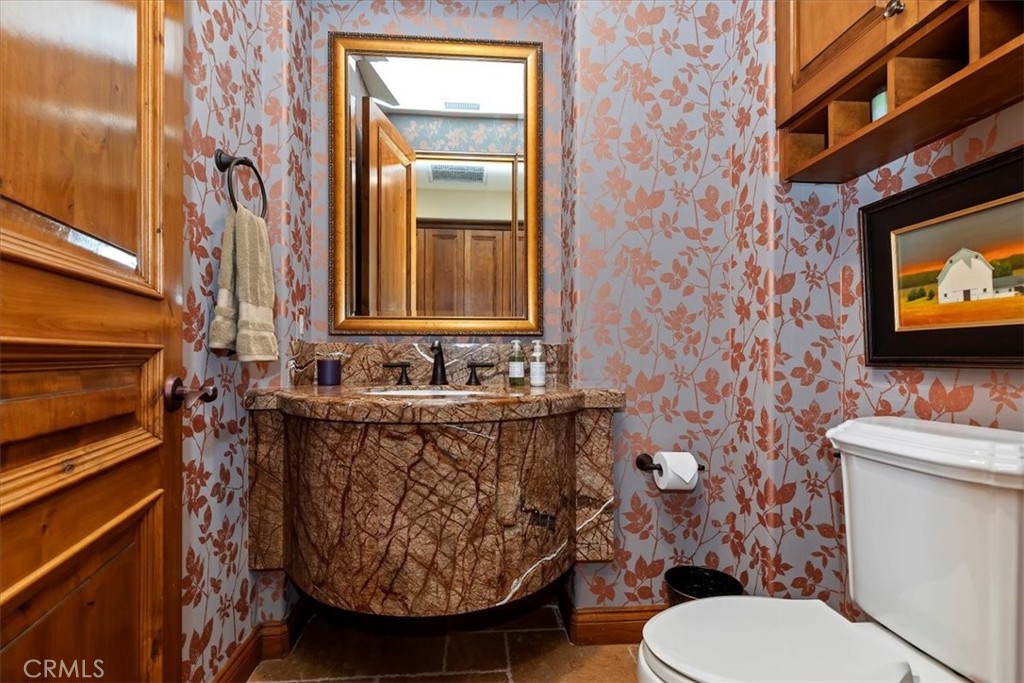 41 Cassis Circle Rancho Mirage, CA 92270 - Photo 27 of 74 a bathroom with a sink a toilet and mirror