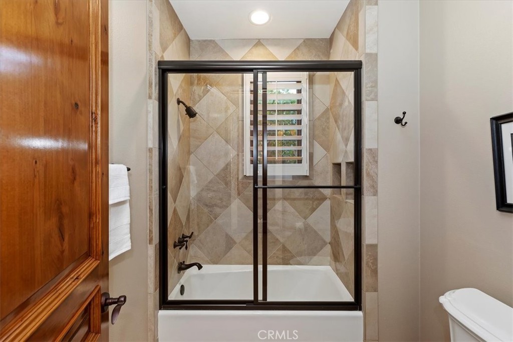 41 Cassis Circle Rancho Mirage, CA 92270 - Photo 39 of 74 a bathroom with a glass shower door