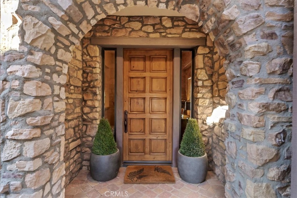 41 Cassis Circle Rancho Mirage, CA 92270 - Photo 4 of 74 a view of a door of the house with a potted plant