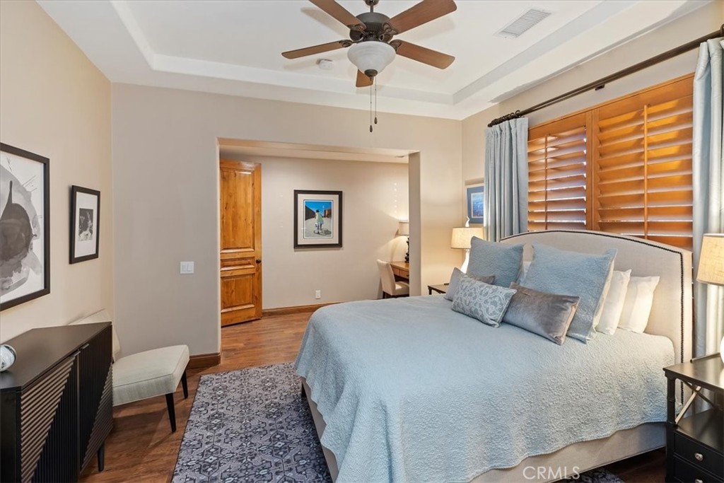 41 Cassis Circle Rancho Mirage, CA 92270 - Photo 43 of 74 a bedroom with a bed and wooden floor