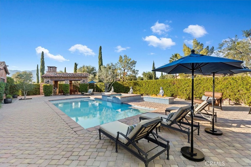 41 Cassis Circle Rancho Mirage, CA 92270 - Photo 50 of 74 a view of a swimming pool with lounge chairs