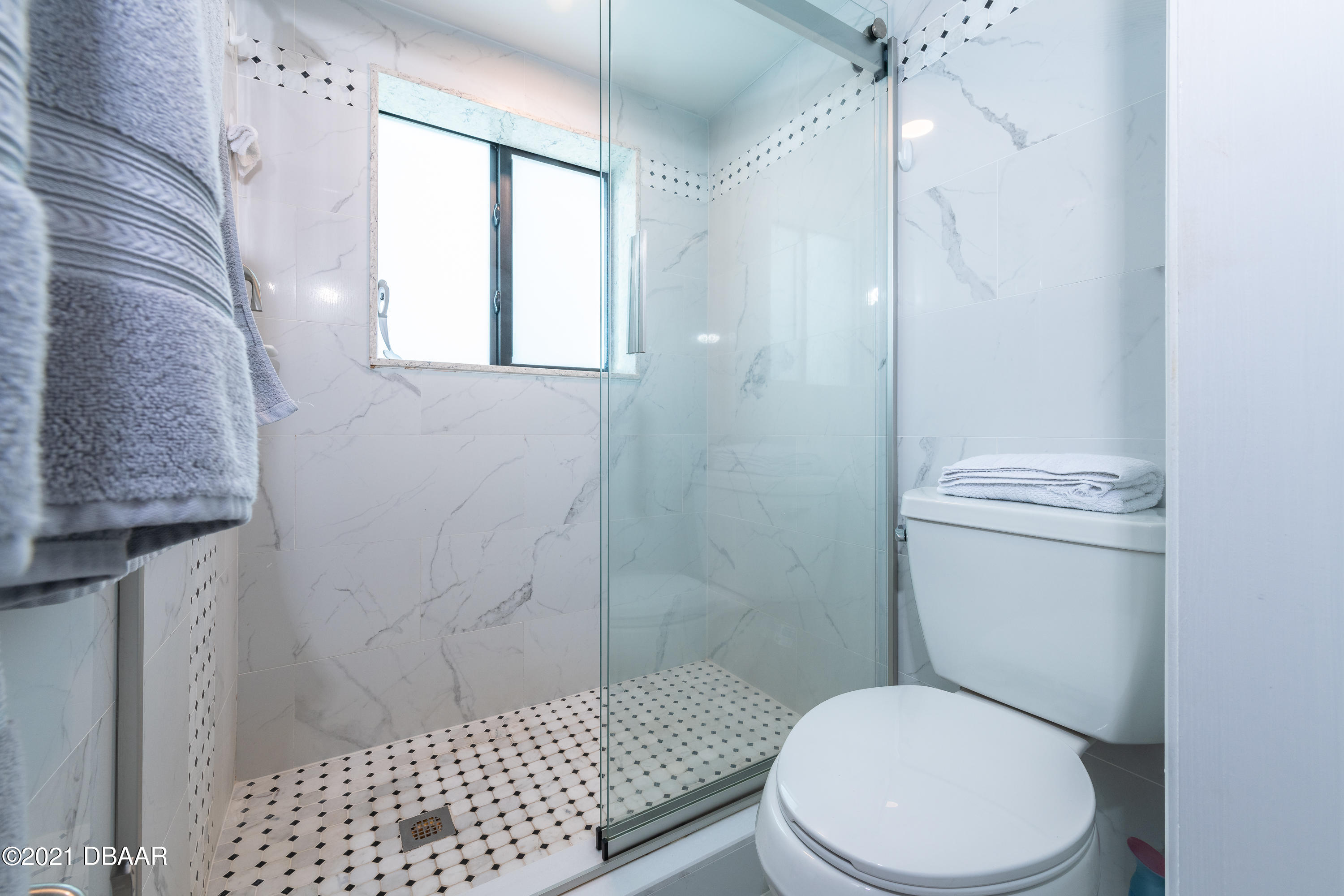 1275 Ocean Shore Boulevard, Unit 307 Ormond Beach, FL 32176 - Photo 12 of 24 a white toilet sitting next to a bathroom sink
