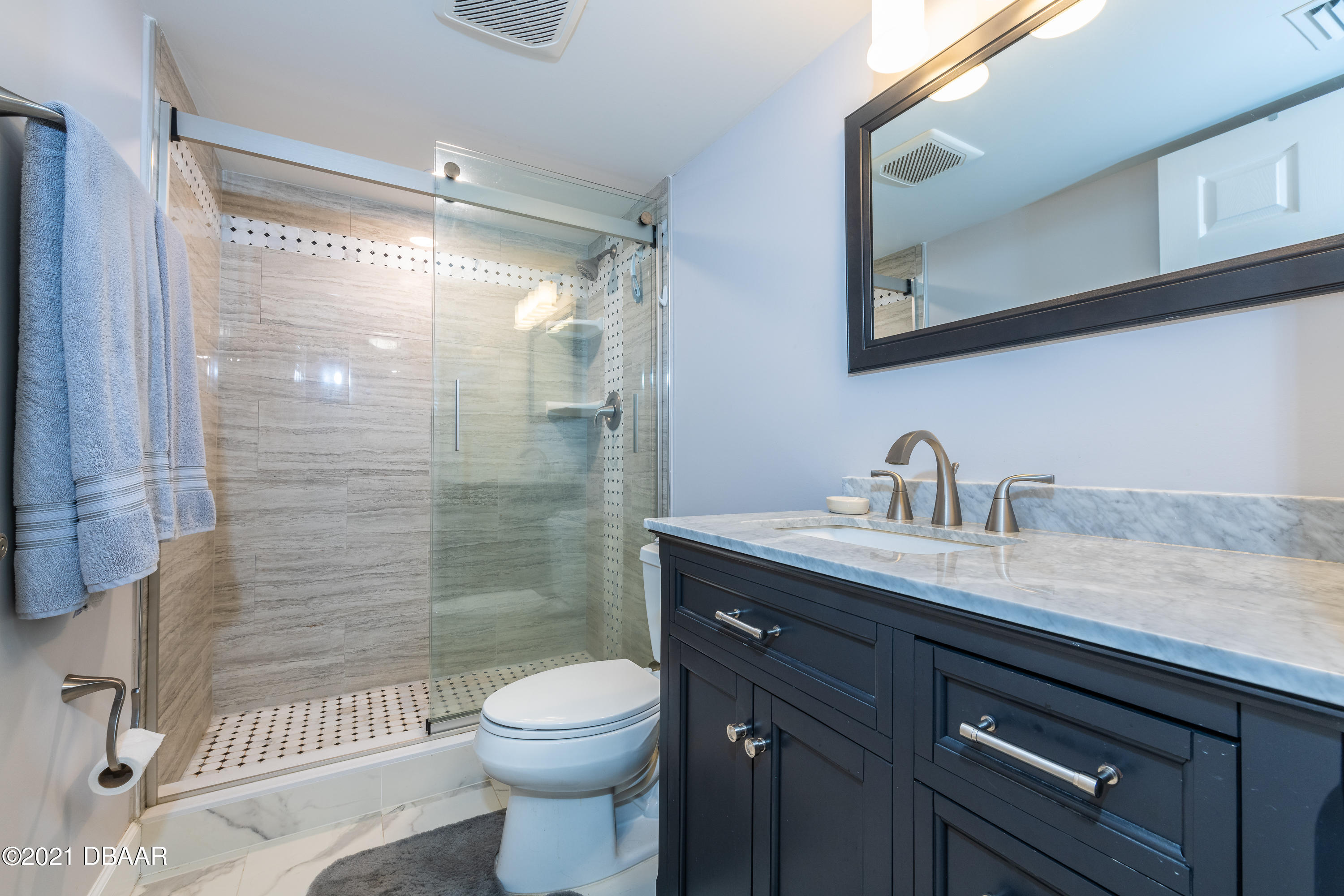 1275 Ocean Shore Boulevard, Unit 307 Ormond Beach, FL 32176 - Photo 14 of 24 a bathroom with a granite countertop sink toilet and shower