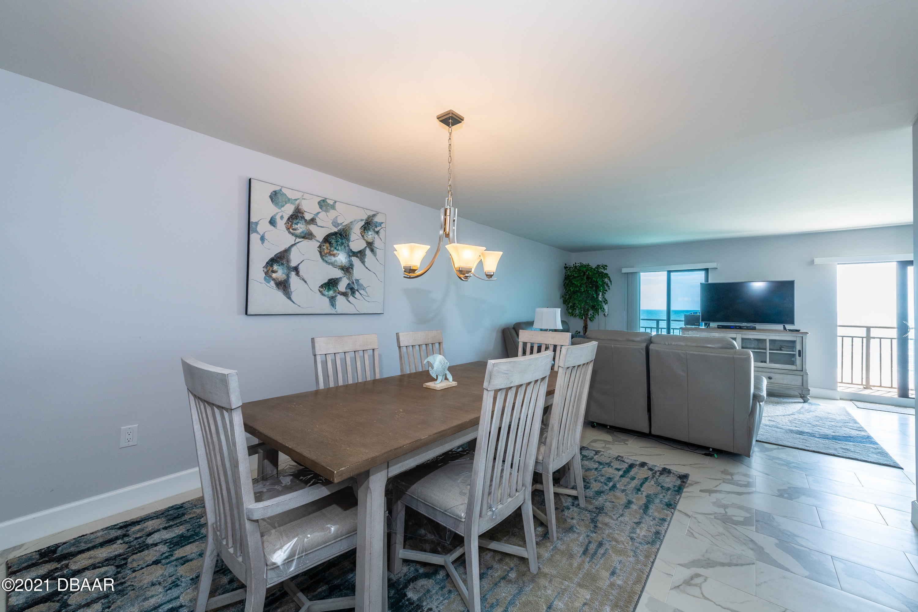 1275 Ocean Shore Boulevard, Unit 307 Ormond Beach, FL 32176 - Photo 15 of 24 a dining room with furniture and wooden floor