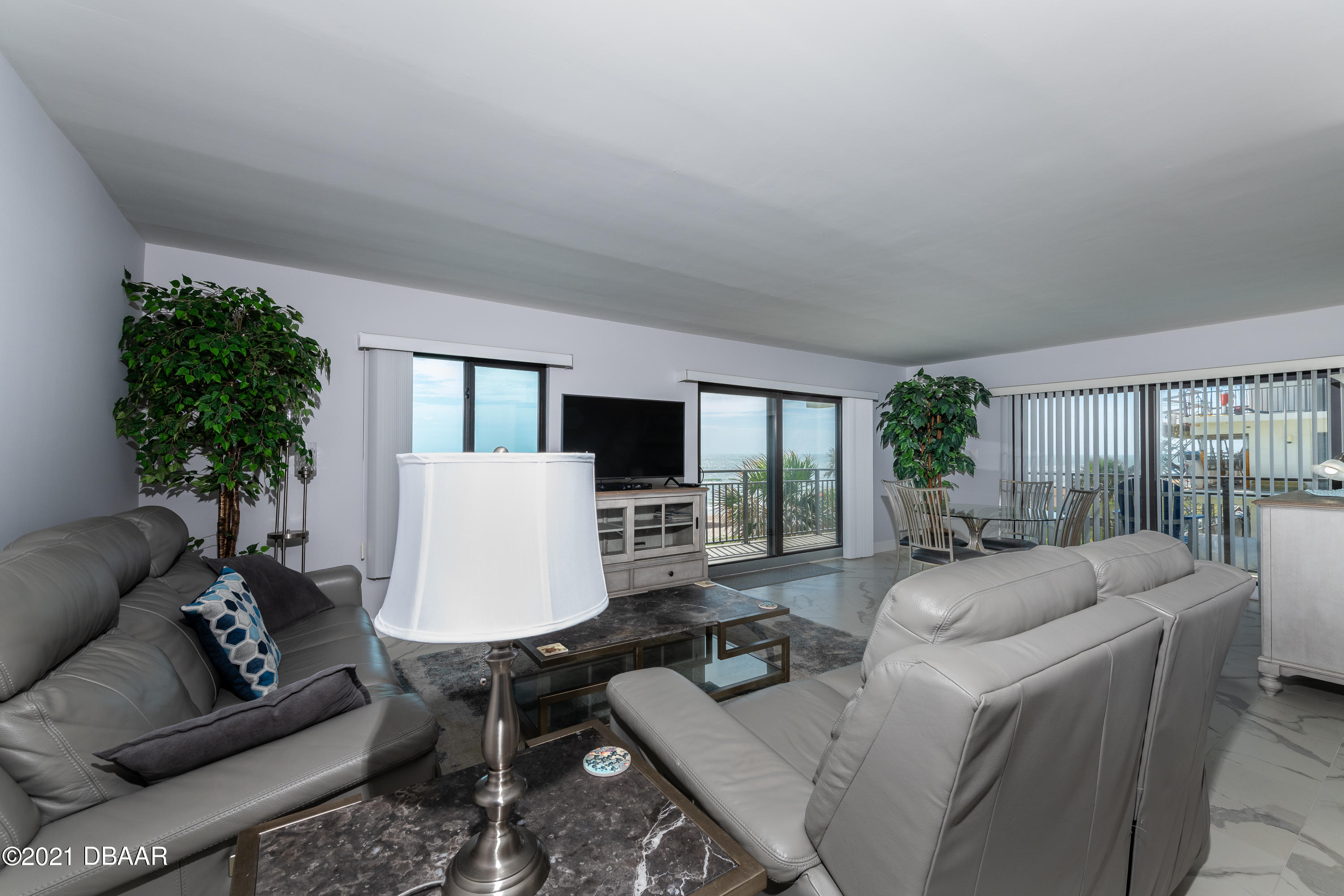 1275 Ocean Shore Boulevard, Unit 307 Ormond Beach, FL 32176 - Photo 16 of 24 a living room with furniture a flat screen tv and a large window