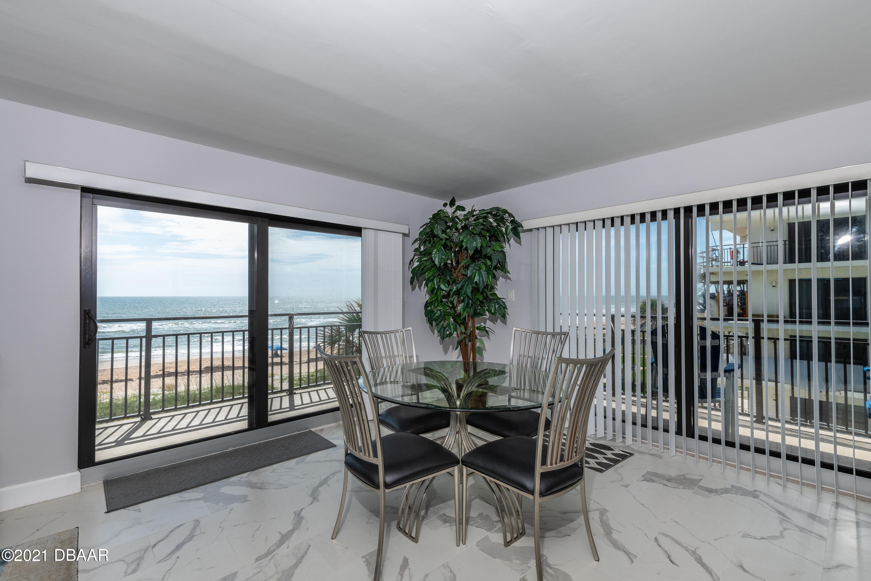 1275 Ocean Shore Boulevard, Unit 307 Ormond Beach, FL 32176 - Photo 17 of 24 a dining room with furniture and floor to ceiling window