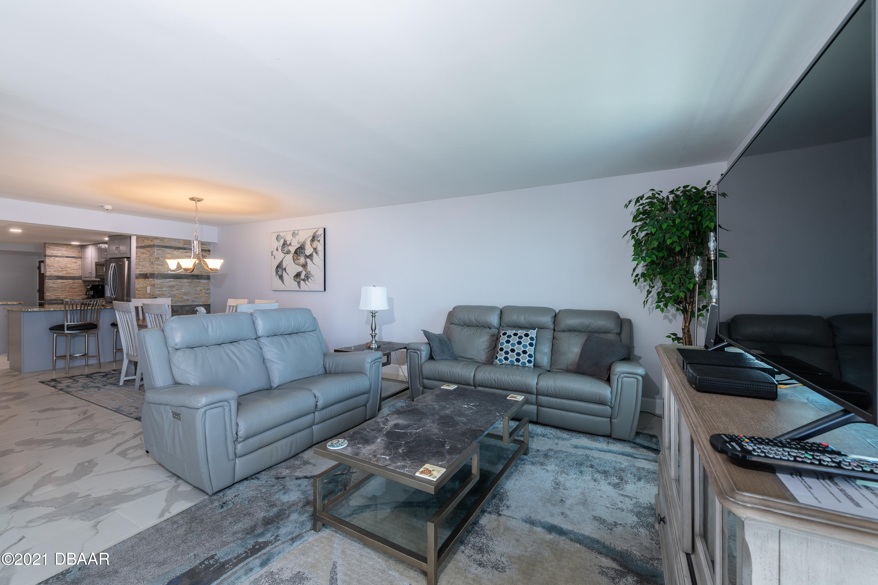1275 Ocean Shore Boulevard, Unit 307 Ormond Beach, FL 32176 - Photo 18 of 24 a living room with furniture and a flat screen tv