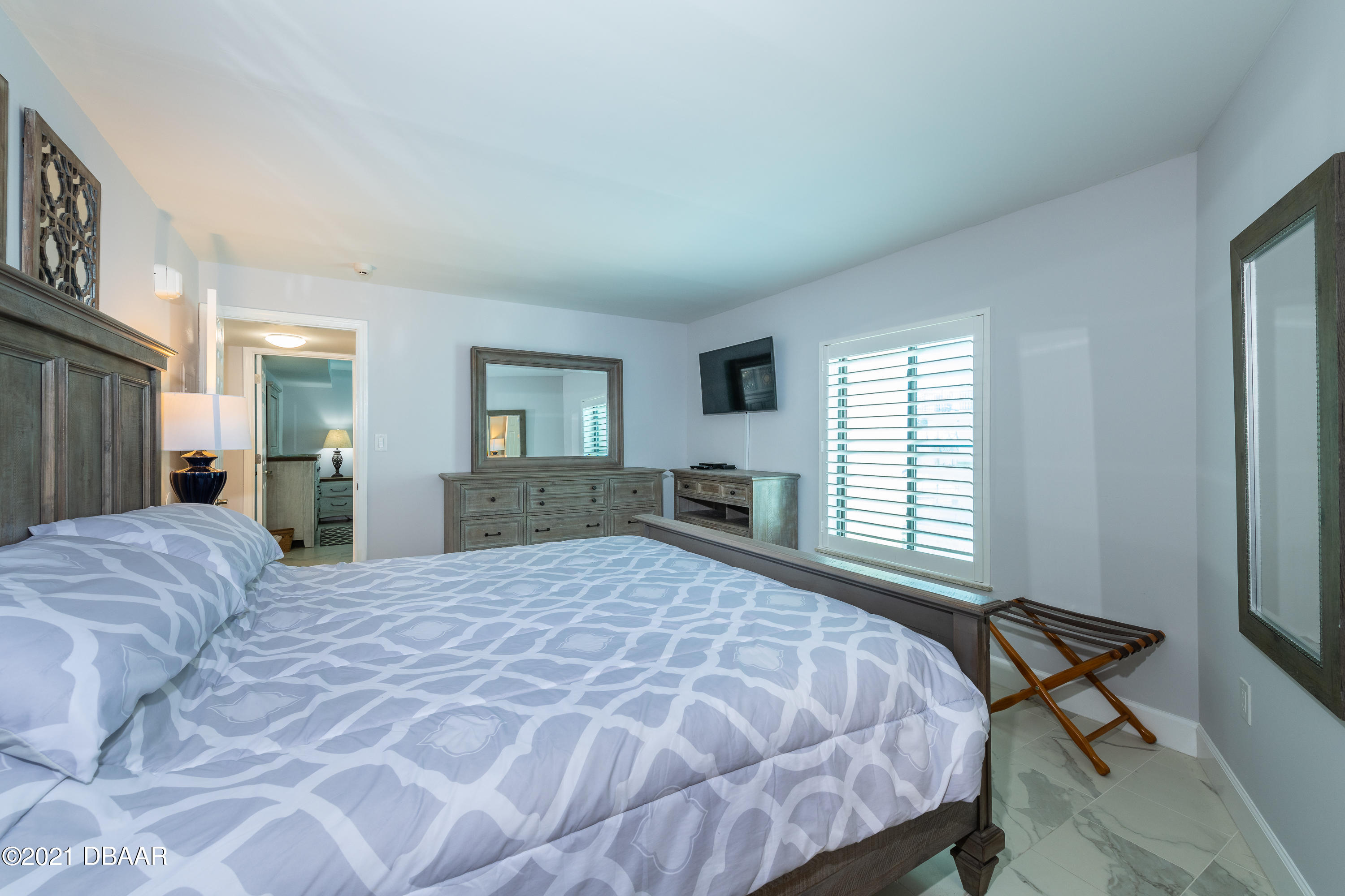 1275 Ocean Shore Boulevard, Unit 307 Ormond Beach, FL 32176 - Photo 10 of 24 a bedroom with a large bed and a window