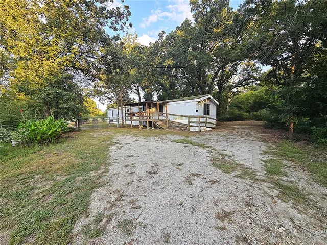 a view of a yard with large trees