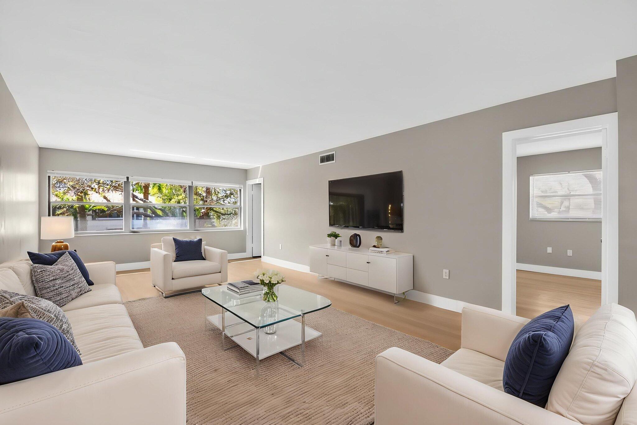 2018 Southwest 29th Court, Unit 642 Delray Beach, FL 33445 - Photo 11 of 23 a living room with furniture and a flat screen tv