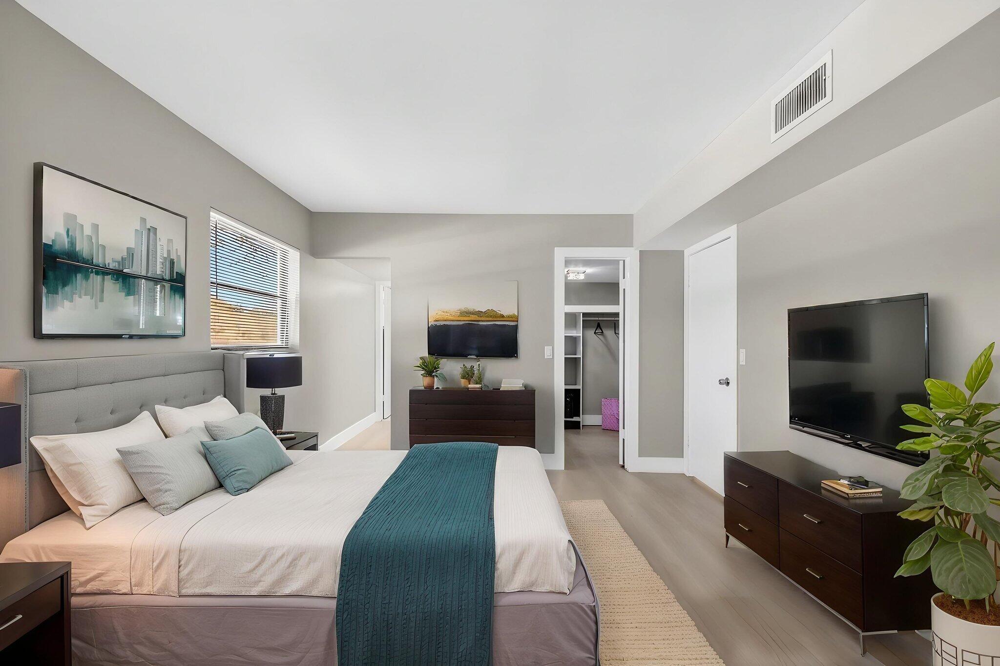 2018 Southwest 29th Court, Unit 642 Delray Beach, FL 33445 - Photo 12 of 23 a bedroom with a bed and a flat screen tv