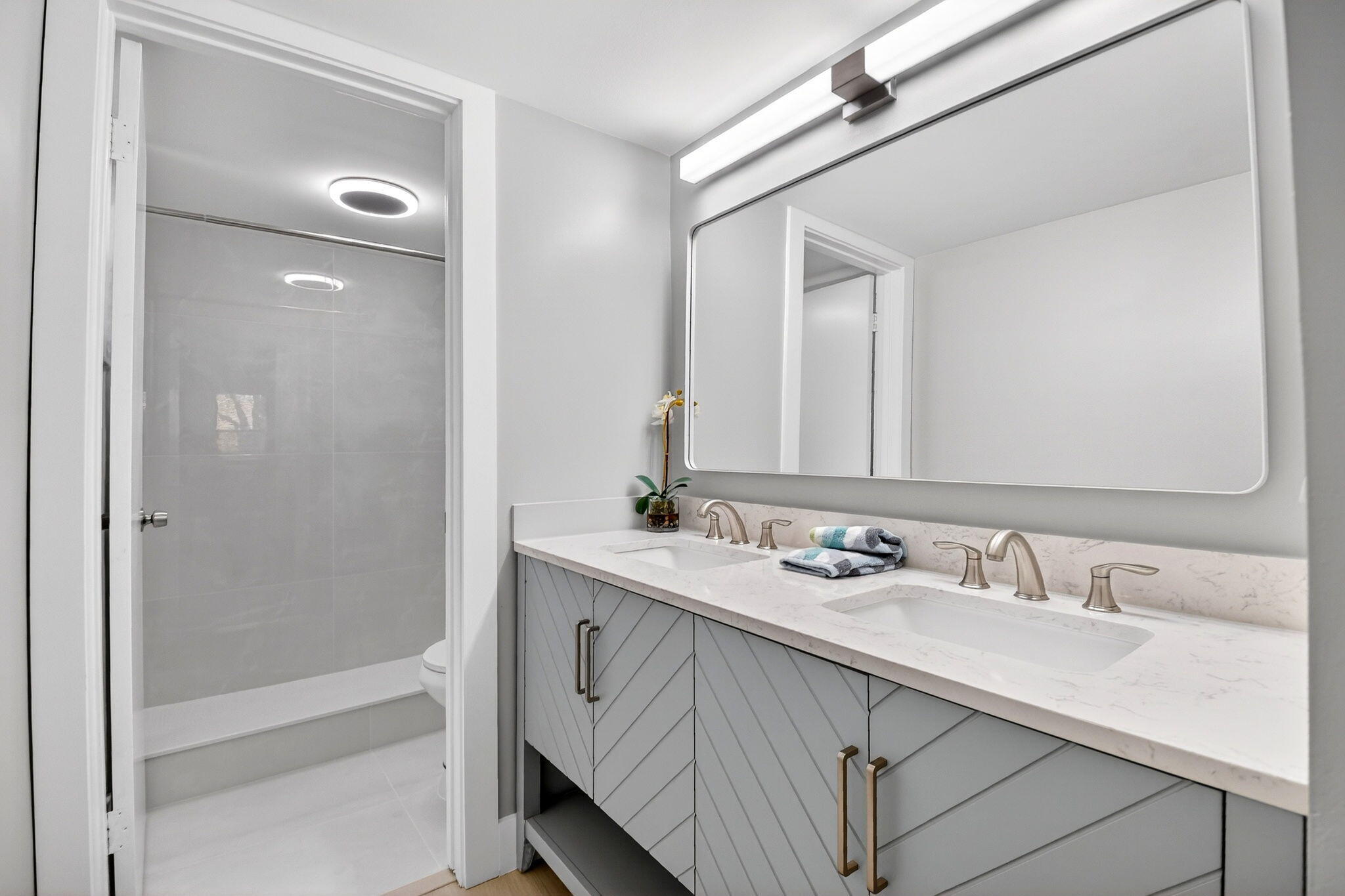 2018 Southwest 29th Court, Unit 642 Delray Beach, FL 33445 - Photo 13 of 23 a bathroom with a sink double vanity and a mirror
