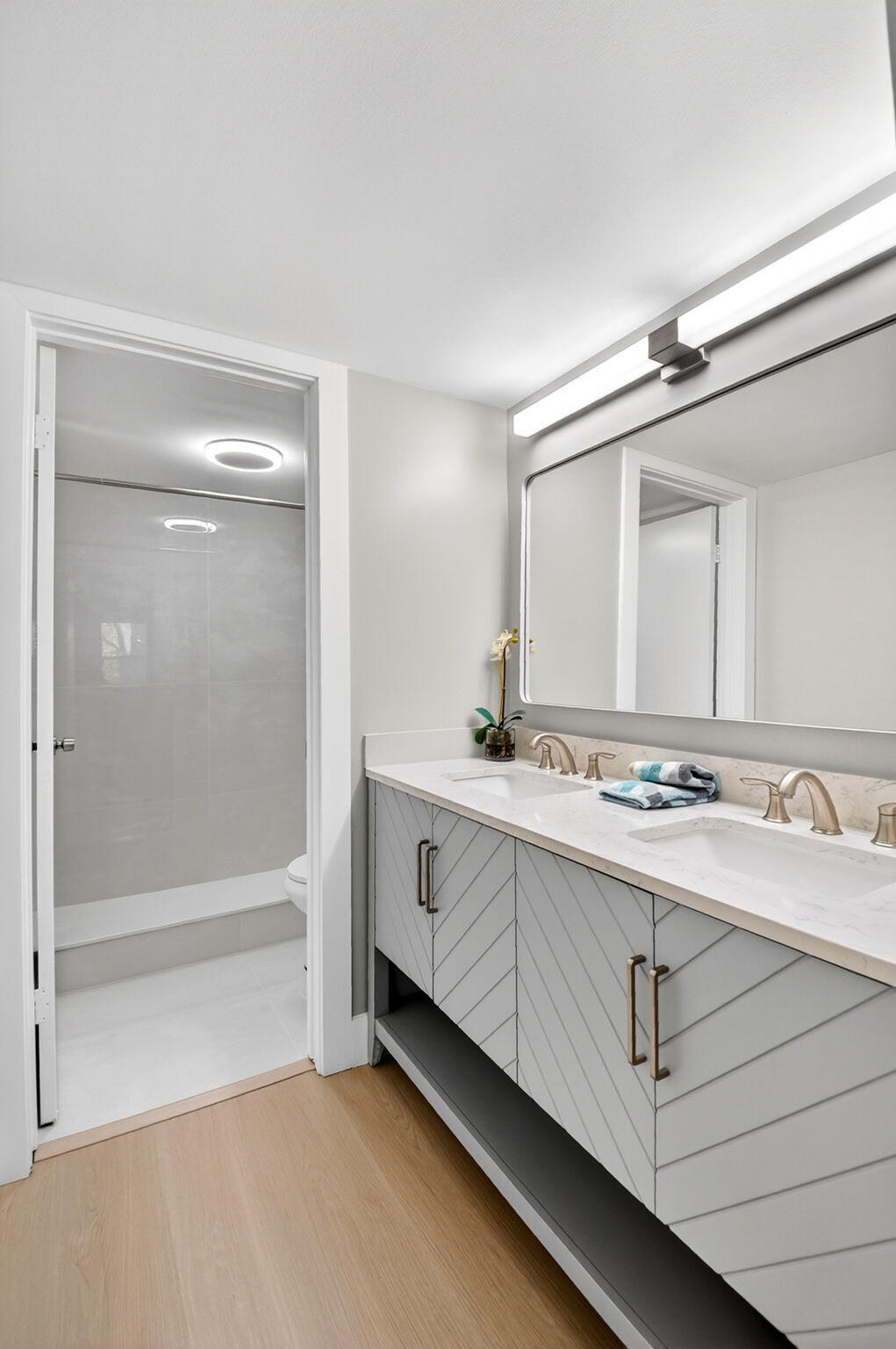 2018 Southwest 29th Court, Unit 642 Delray Beach, FL 33445 - Photo 14 of 23 a bathroom with a double vanity sink mirror and shower