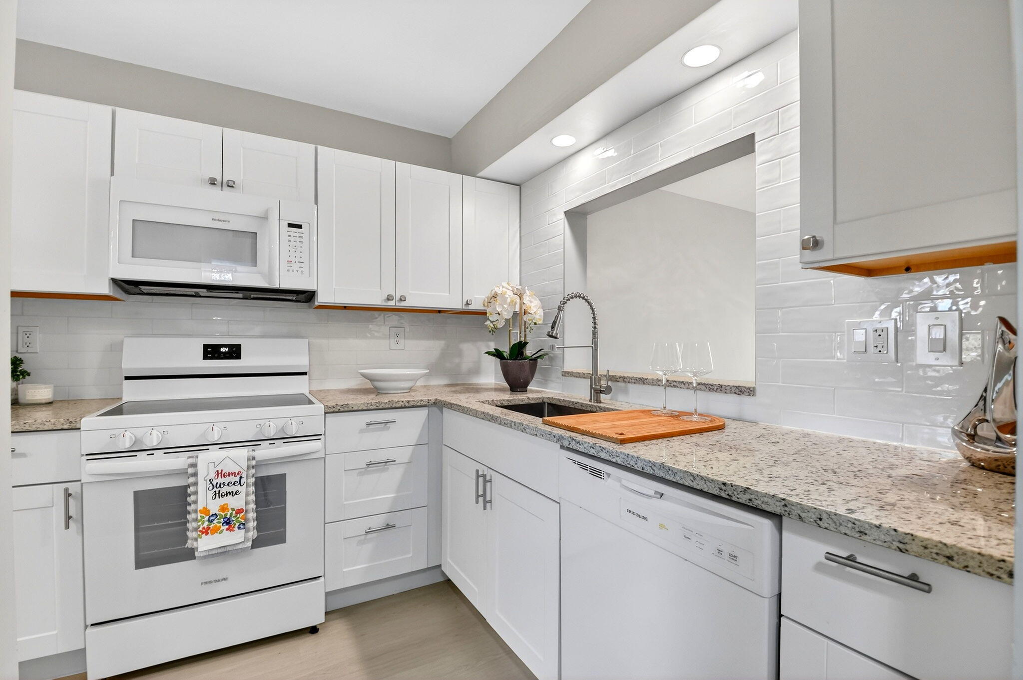 2018 Southwest 29th Court, Unit 642 Delray Beach, FL 33445 - Photo 5 of 23 a kitchen with white cabinets sink and stove