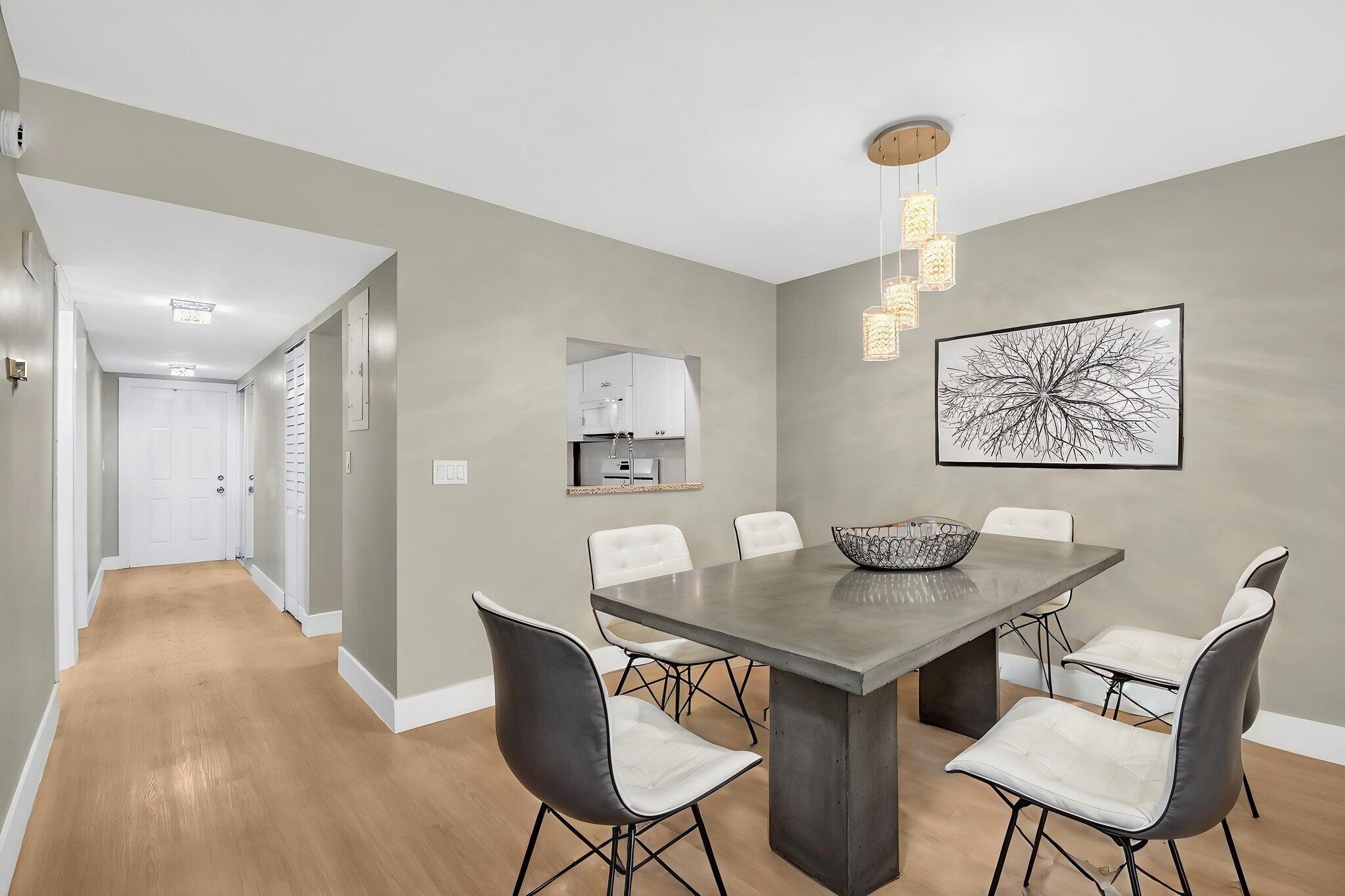 2018 Southwest 29th Court, Unit 642 Delray Beach, FL 33445 - Photo 9 of 23 a view of a dining room with furniture and wooden floor