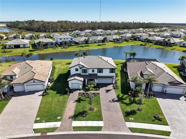 an aerial view of residential houses with outdoor space and river