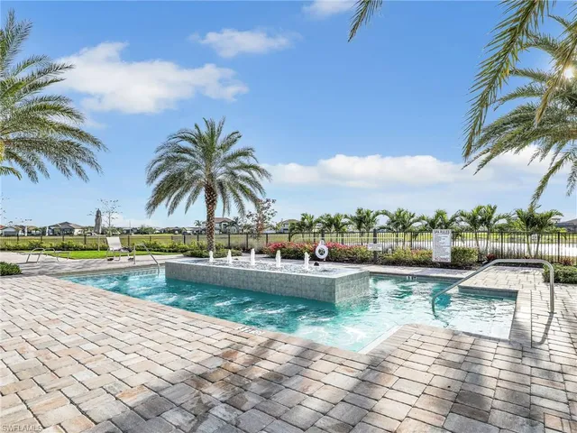 a view of swimming pool with outdoor seating and lake view