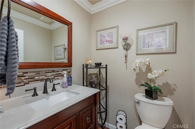 a bathroom with a toilet a sink and a mirror