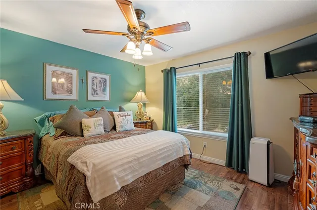 a bedroom with a large bed and a flat tv screen on a dresser