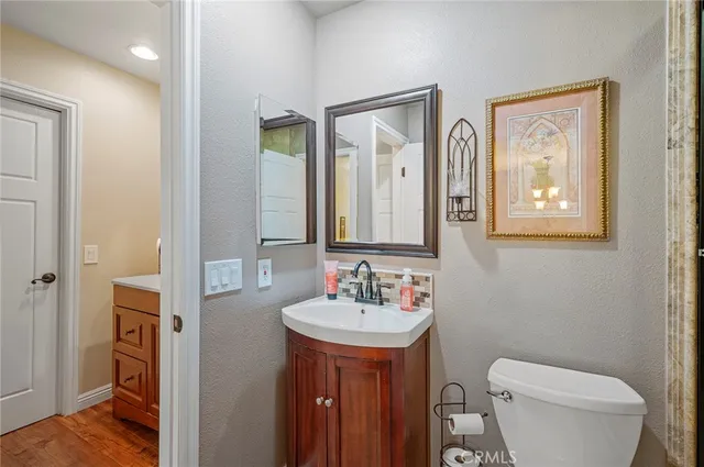 a bathroom with a toilet a sink and mirror