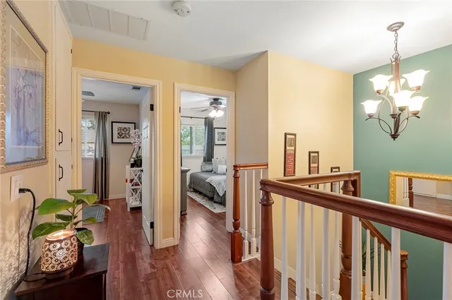 a view of a hallway to a livingroom with furniture