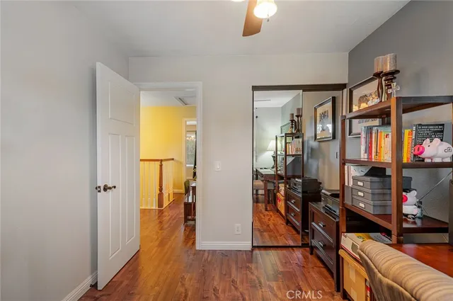 a view of hallway with wooden floor and furniture