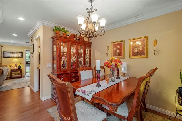 a dining room with furniture and chandelier