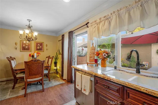 a dining room with furniture a chandelier and wooden floor