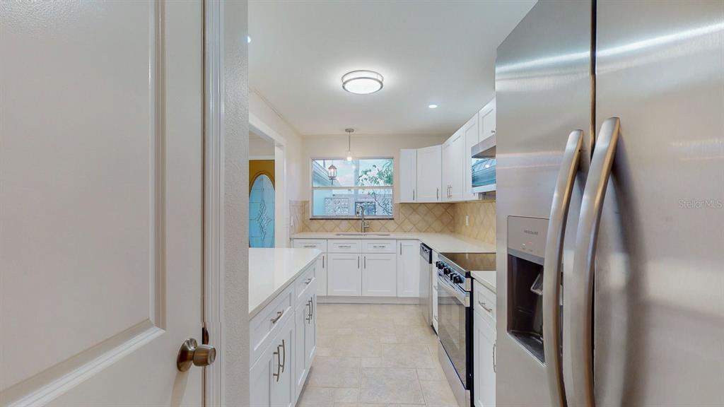 636 Boca Ciega Point Boulevard South St. Petersburg, FL 33708 - Photo 12 of 96 a kitchen with stainless steel appliances granite countertop a refrigerator and a sink