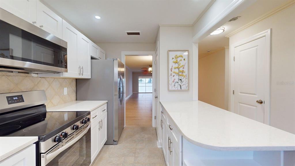 636 Boca Ciega Point Boulevard South St. Petersburg, FL 33708 - Photo 15 of 96 a kitchen with stainless steel appliances a stove microwave and cabinets