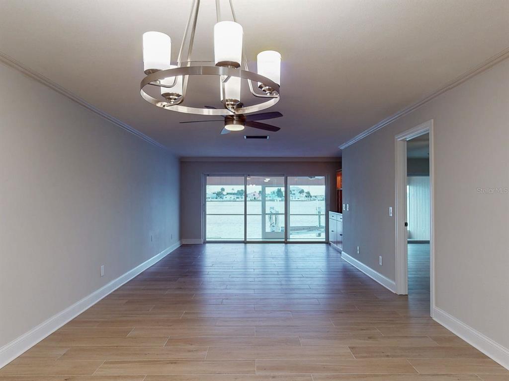 636 Boca Ciega Point Boulevard South St. Petersburg, FL 33708 - Photo 24 of 96 wooden floor in an empty room with a window