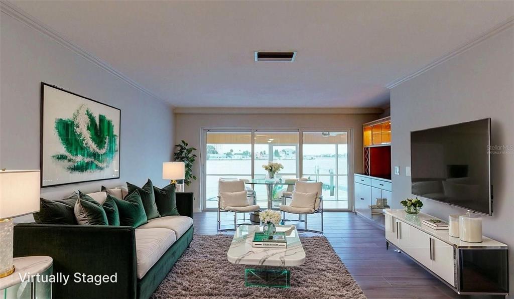 636 Boca Ciega Point Boulevard South St. Petersburg, FL 33708 - Photo 29 of 96 a living room with furniture and a flat screen tv