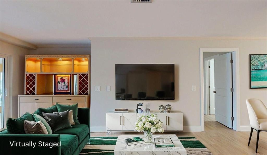 636 Boca Ciega Point Boulevard South St. Petersburg, FL 33708 - Photo 33 of 96 a living room with furniture and a flat screen tv