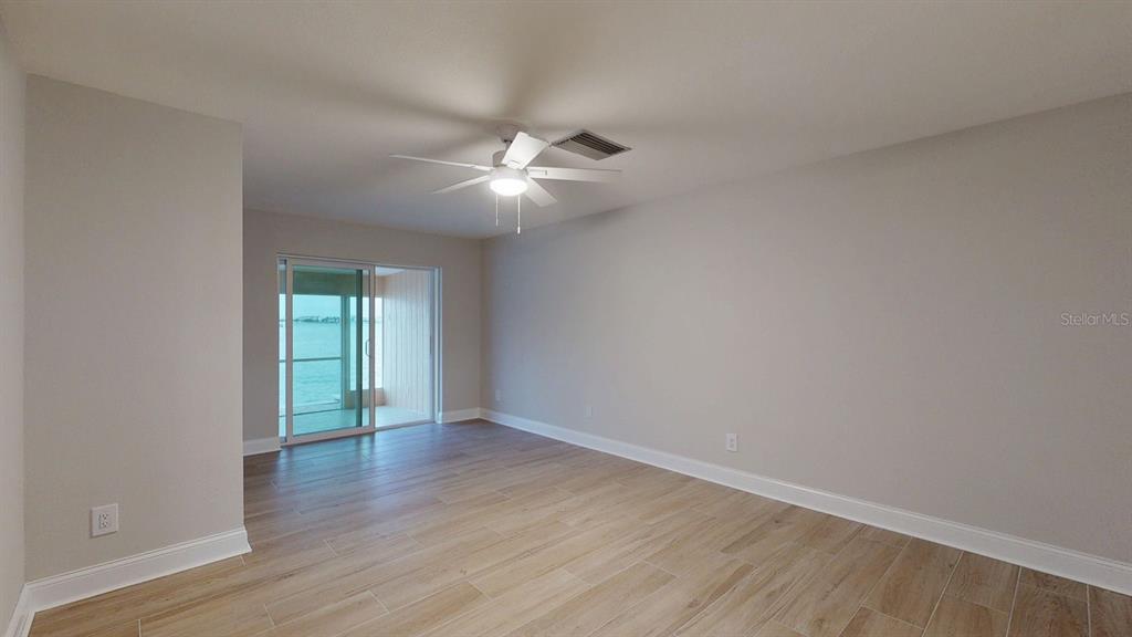 636 Boca Ciega Point Boulevard South St. Petersburg, FL 33708 - Photo 36 of 96 a view of an empty room with wooden floor and a window