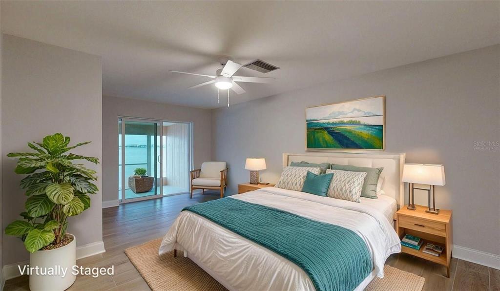 636 Boca Ciega Point Boulevard South St. Petersburg, FL 33708 - Photo 37 of 96 a bedroom with a bed and a chandelier